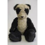 A 22" high Panda, 1940's, with amber eyes and leather pads (Est. plus 21% premium inc. VAT)