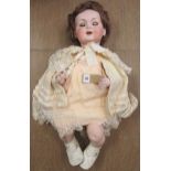 An Armand Marseille bisque socket head doll with brown glass sleeping eyes, open mouth with two