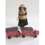 A Kammer & Reinhardt bisque socket head doll, with brown glass sleeping eyes, open mouth, bent