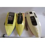 Three model racing boat hulls, wood and fibre glass construction, with two engine exhaust pipes,