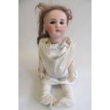 An S.F.B.J. bisque socket head doll with blue glass eyes, open mouth with six moulded top teeth,