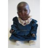 A bisque socket head mulatto baby doll, with brown glass sleeping eyes, moulded hair, closed