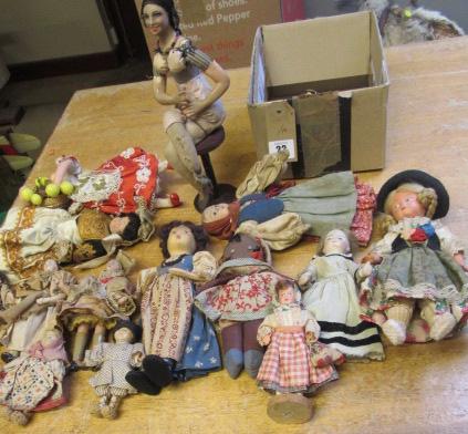 A collection of fourteen national costume and other small dolls including a Victorian German