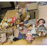 A collection of fourteen national costume and other small dolls including a Victorian German