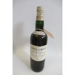 A bottle of 1950s(?) "BLACK & WHITE" Buchanan's choice old scotch whisky, with white label and