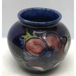 A Moorcroft Anenome pattern vase. 8cms h, paper label to base. Good condition.
