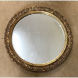 Gilt framed circular bevel edge wall mirror. 49cms w