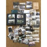 A postcard album and contents with loose postcards including topographical and pre WW I military