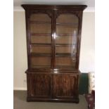 A 19thC good quality mahogany bookcase, 2 glazed doors over cupboard base with shelves and drawers