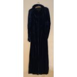 A blue and velvet evening coat with ruched sleeves and button front.