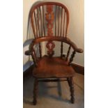 A 19thC broad arm Windsor high back chair, modified seat.