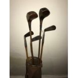 Vintage golf bag and five hickory shafted clubs c1920/30 some hand forged.