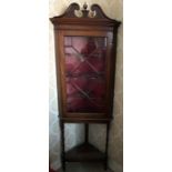 Mahogany corner cupboard with glazed single door on stand. 60cms w x 182cms h.