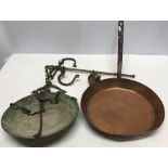 Swiss brass hanging scales and a copper frying pan.