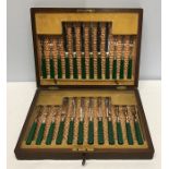 Mahogany cased cutlery, 12 place set silver collars with green handles.