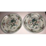A pair of fine and rare doucai 'dragon' saucer dishes. Yongzheng six character mark and of the