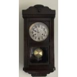 Oak cased chiming wall clock. 54cms h.
