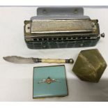 Miscellany including onyx paperweight, butter knife, Super Chromonica Harmonica and an RAF powder