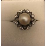 A cultured pearl and diamond set ring 18 ct white gold, circa 1960's/70's. Size N. 6.5gms.