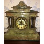 Mantle clock in onyx case with brass pillars. Paris made. Onyx slight a/f at one side. 35cms h.