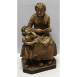Early 20thC figure of Grandmother and child, marked Pans (F) to rear. Some slight chips.