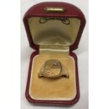 A 9ct gold signet ring set with diamond, size S/T. 8.4gms.