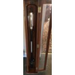 Stick barometer in glazed wooden case.