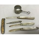 Three silver mother of pearl fruit knives, propelling pencil, Egyptian motif fruit knife and