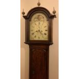 An oak cased longcase clock with mahogany cross banding a rolling moon, maker Braham Tourquay.