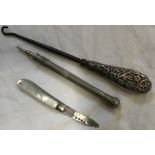A silver handled button hook, mother of pearl pen knife with silver blade and a silver plated