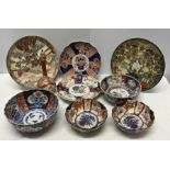 Imari patterned plates, bowls and a vase. (9)