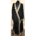 A long black cream lace trimmed robe with scalloped hem. Label for Adapto.