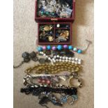 A large quantity of costume jewellery to include beads, bracelets etc.