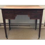 A 19thC mahogany and inlaid desk on original brass castors, one long over two small drawers.