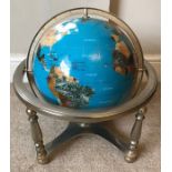 A terrestrial polished aggregate stone globe on stand.