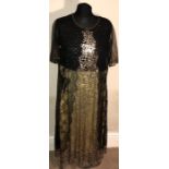 A black net evening dress with sequinned panel, short gold embroidered sleeves. A yellow