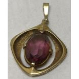 A 9ct gold pendant set with purple stone. 4.9gms total.