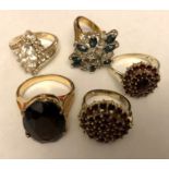 Five ladies dress rings, all unmarked metal.