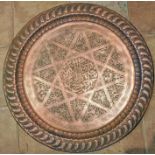 A large Arabic copper tray. 62.5cms d. 5.7kgs.