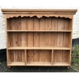 A pine wall mounted 3 height shelf unit, 110cms h x 125cms w.