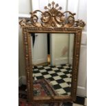 Large decorative gilt framed bevel edge wall mirror. 73cms w x 127cms .