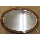 An oval Edwardian mahogany inlaid mirror. 84 x 59cms.