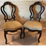 A pair of rosewood occasional chairs with cabriole legs.