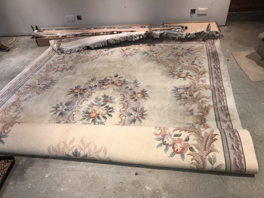 A large cream wool Chinese carpet. 351cms x 259cms.