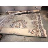 A large cream wool Chinese carpet. 351cms x 259cms.