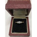 A 3 stone diamond ring mounted in 18ct gold and platinum, size M/N. 2.3gms approx.