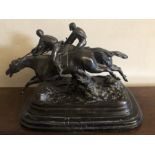 A bronze 20th century figure of two racehorses approaching the finish. Signed to base E.Loiseau.