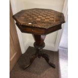 A 19th century walnut inlaid sewing table with chess board top.