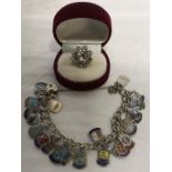 Silver charm bracelet with enamel charms marked silver together with flower brooch set in white