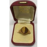 An 18ct gold ring set with tigers eye stone, size M/N. 8.2gms total.